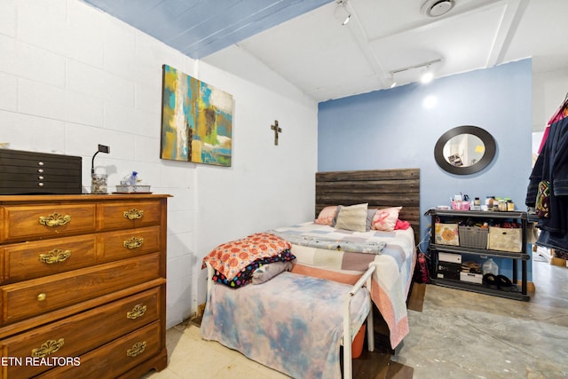 bedroom featuring rail lighting