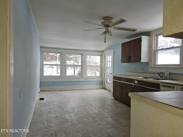 kitchen with lofted ceiling, light tile flooring, ceiling fan, and sink