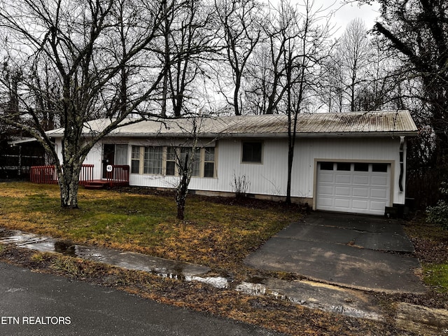 single story home featuring a front lawn and a garage