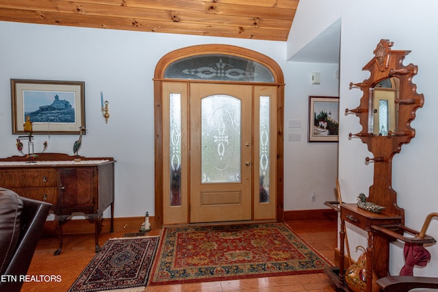 foyer entrance featuring wood-type flooring, plenty of natural light, lofted ceiling, and wood ceiling