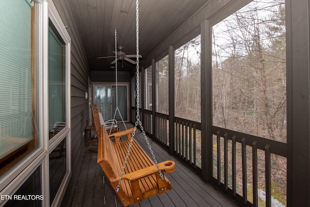 unfurnished sunroom with ceiling fan and wooden ceiling