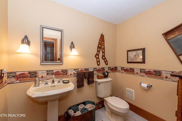 bathroom with tile patterned flooring and toilet