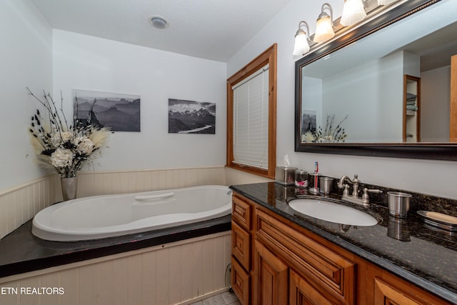 bathroom featuring a washtub and vanity