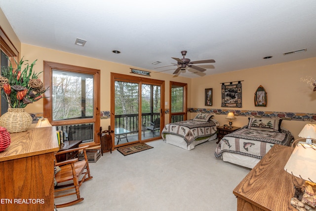 bedroom with access to exterior, light carpet, and ceiling fan