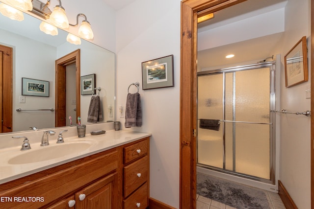 bathroom with tile patterned flooring, vanity, and an enclosed shower