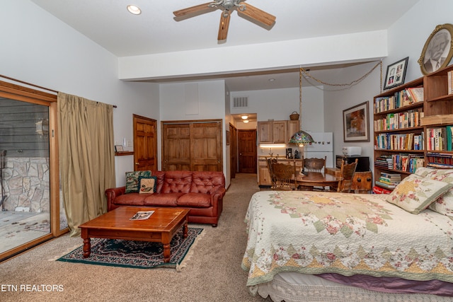 carpeted bedroom with access to exterior, a high ceiling, white fridge, and ceiling fan