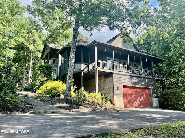 view of front of property featuring a balcony and a garage