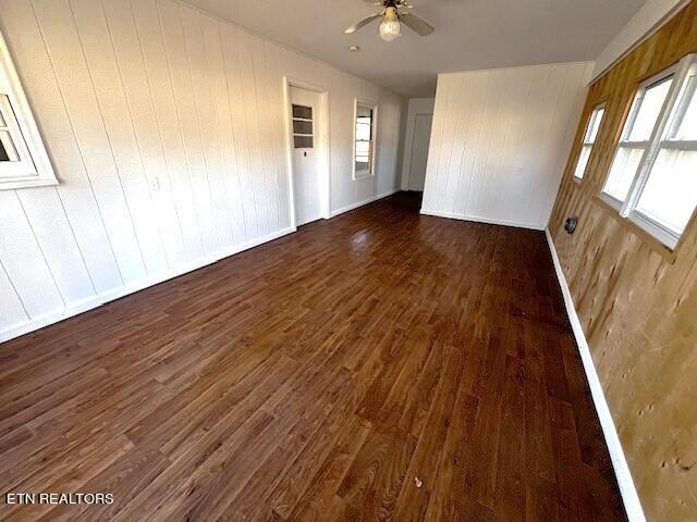 unfurnished room with ceiling fan and dark hardwood / wood-style floors