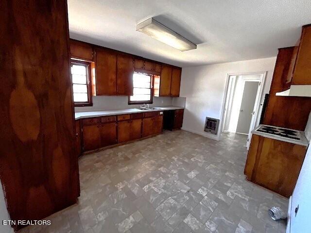 kitchen featuring sink and light tile floors