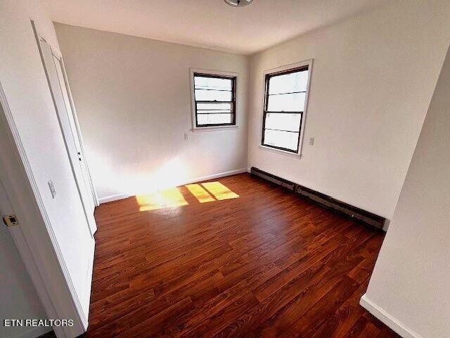 empty room featuring dark wood-type flooring