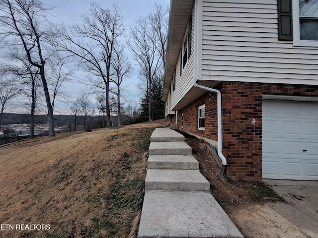 view of side of home with a garage