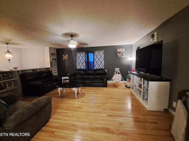 living room featuring light hardwood / wood-style floors and ceiling fan