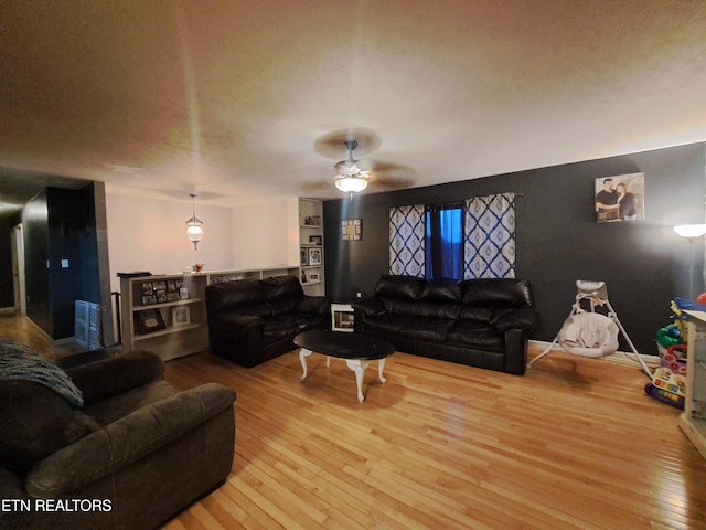 living room with ceiling fan and light wood-type flooring