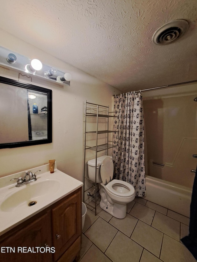 full bathroom featuring toilet, shower / tub combo, tile flooring, a textured ceiling, and vanity