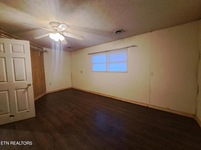 spare room featuring ceiling fan and dark hardwood / wood-style flooring