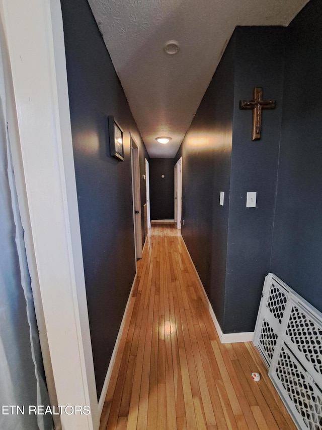 corridor with light wood-type flooring