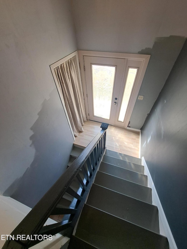 staircase featuring hardwood / wood-style flooring