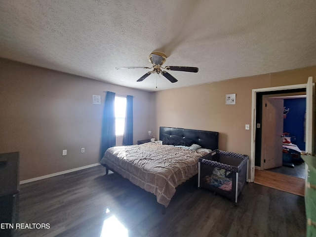 bedroom with a textured ceiling, ceiling fan, and dark hardwood / wood-style floors