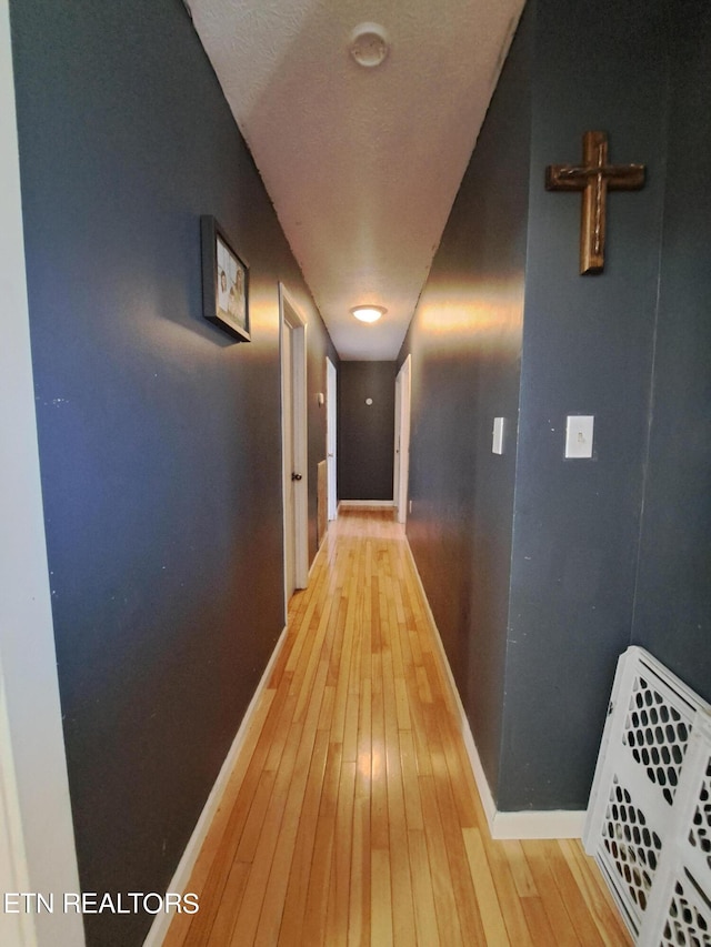 hall with light hardwood / wood-style floors