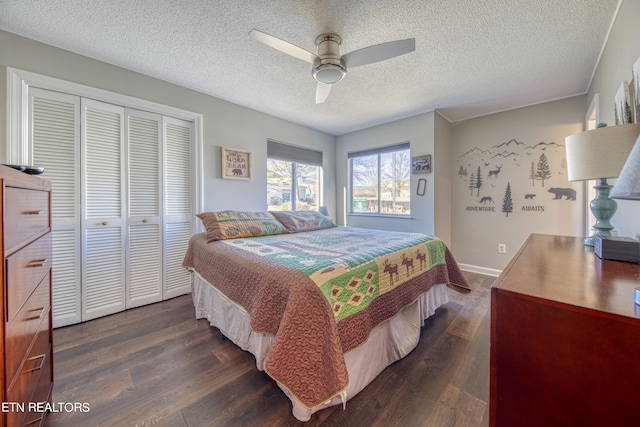 bedroom featuring a textured ceiling, dark hardwood / wood-style flooring, a closet, and ceiling fan