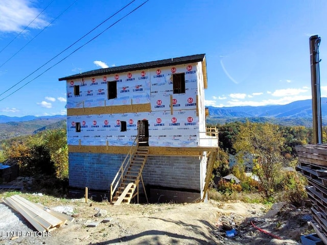 view of side of home featuring a mountain view