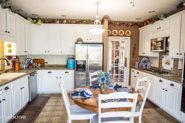352 Rutherford Dr, New Tazewell, TN 37825 - kitchen with dark tile floors, backsplash, sink, and stainless steel appliances