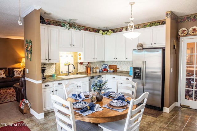 352 Rutherford Dr, New Tazewell, TN 37825 - kitchen featuring decorative light fixtures, white cabinetry, appliances with stainless steel finishes, dark tile floors, and tasteful backsplash