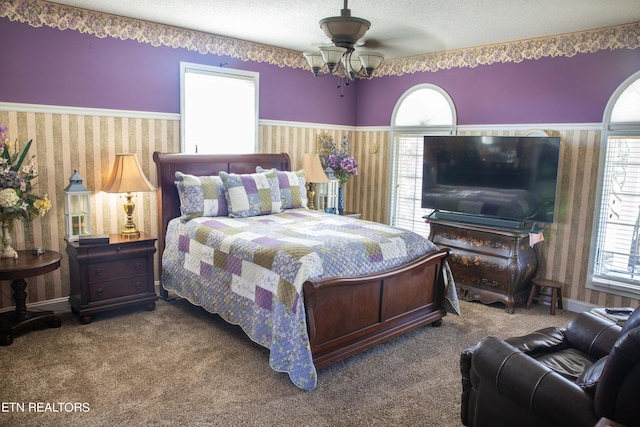 352 Rutherford Dr, New Tazewell, TN 37825 - bedroom with a textured ceiling, dark carpet, multiple windows, and ceiling fan with notable chandelier