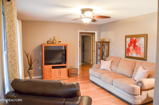 living room featuring hardwood / wood-style flooring and ceiling fan