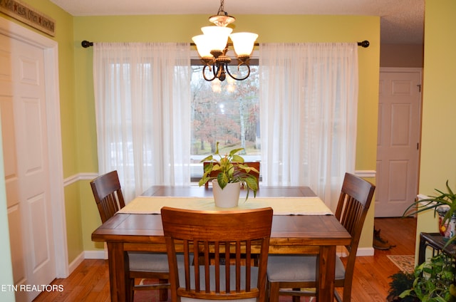 dining room featuring a notable chandelier and wood-type flooring