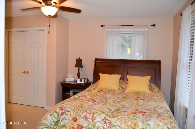 bedroom featuring a textured ceiling, a closet, ceiling fan, and carpet floors