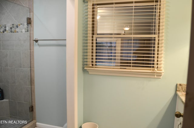 bathroom featuring a shower with door