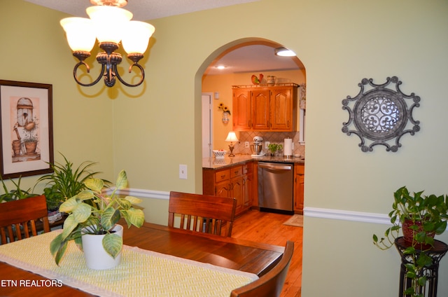 dining room with an inviting chandelier and hardwood / wood-style flooring