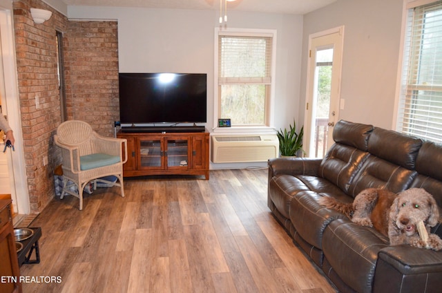 living room with a wood stove and wood-type flooring