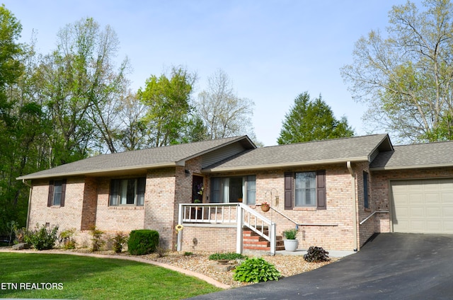 view of front of property with a front lawn and a garage