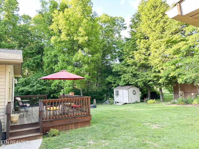 view of yard featuring a shed and a deck