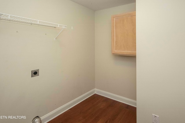 clothes washing area featuring electric dryer hookup and dark wood-type flooring