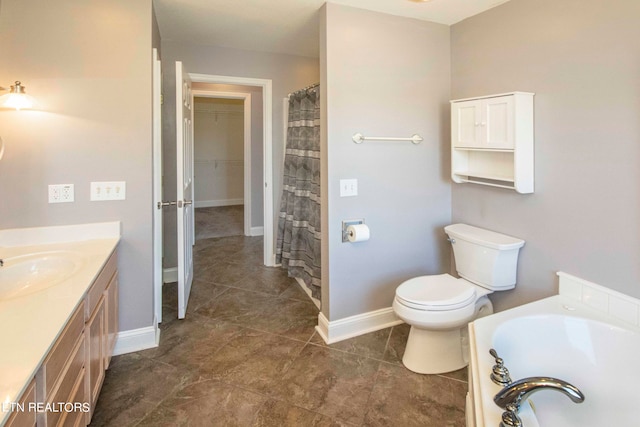 bathroom with toilet, tile floors, vanity, and a bath