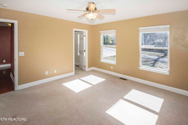 unfurnished room featuring ceiling fan and carpet floors