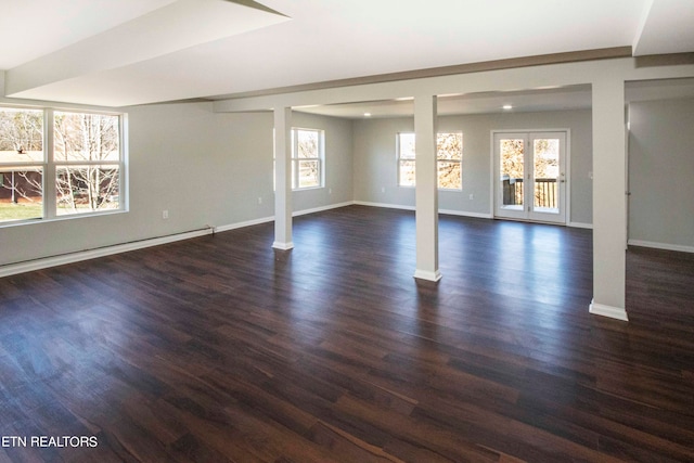 spare room featuring french doors and dark hardwood / wood-style floors