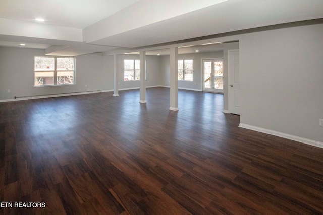 empty room featuring dark hardwood / wood-style flooring and baseboard heating