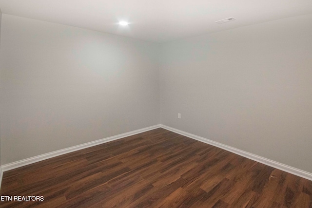 spare room featuring dark hardwood / wood-style flooring