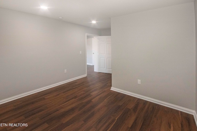 spare room featuring dark wood-type flooring