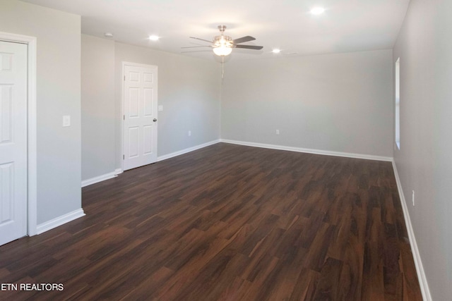 unfurnished room with ceiling fan and dark wood-type flooring