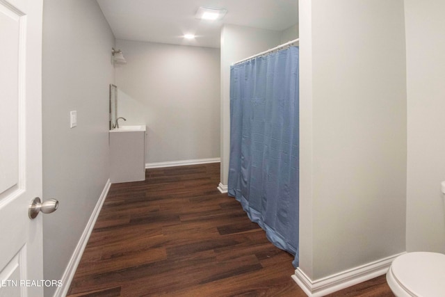 bathroom with sink, toilet, and hardwood / wood-style floors