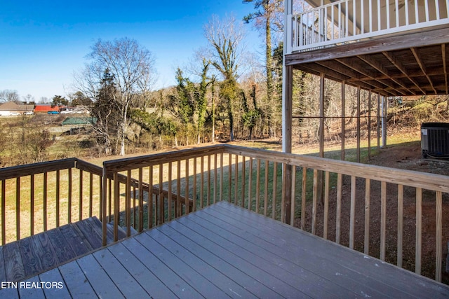 wooden terrace featuring a yard and central air condition unit