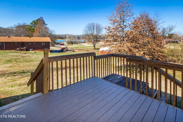 wooden deck with a lawn