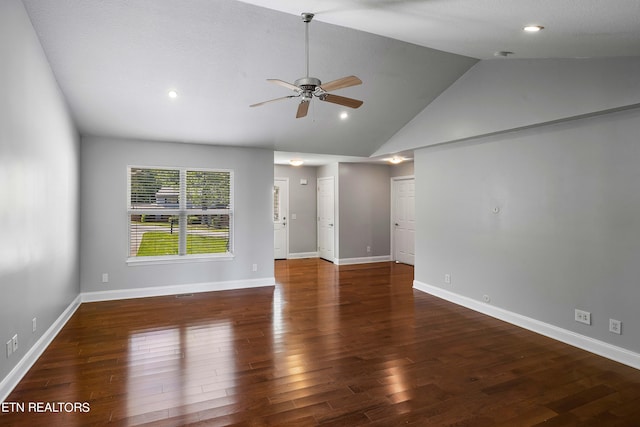 empty room featuring high vaulted ceiling, dark wood-type flooring, and ceiling fan