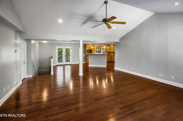 unfurnished living room with lofted ceiling, ceiling fan, and dark hardwood / wood-style flooring