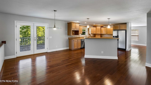 kitchen with french doors, pendant lighting, dark wood-type flooring, and stainless steel appliances